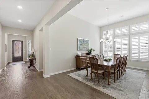 a view of a dining room with furniture and window