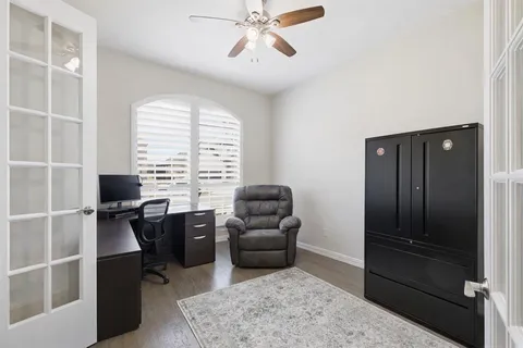 a view of a livingroom with workspace and a window