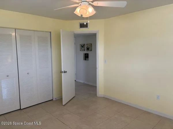 a view of a hallway to rooms