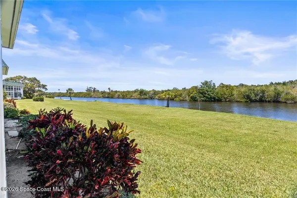 a view of a lake with houses in the back