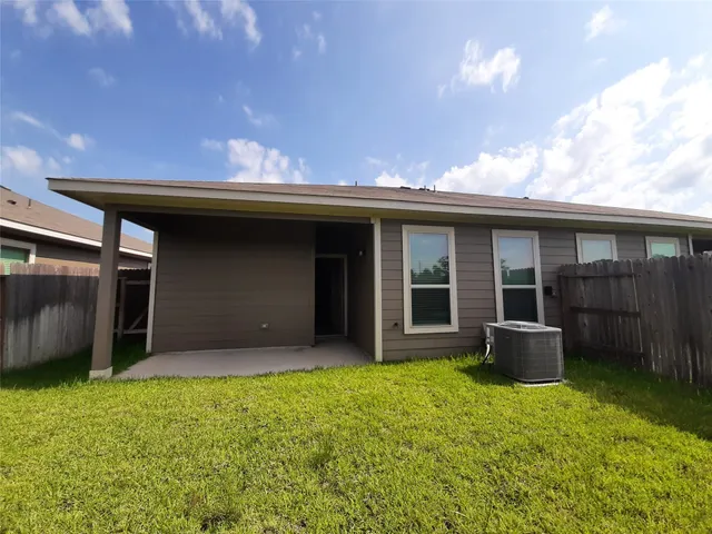 a front view of a house with a garden and yard