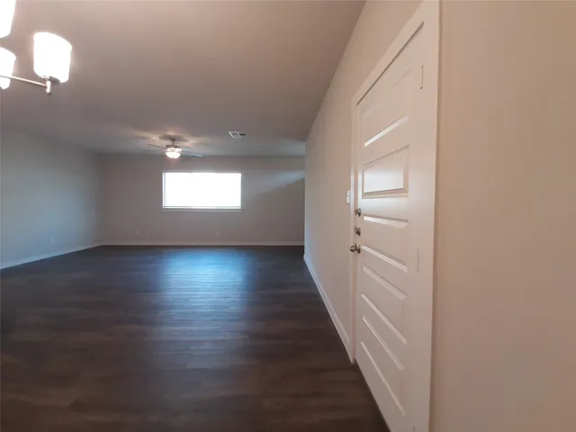 a view of room with window and hardwood floor
