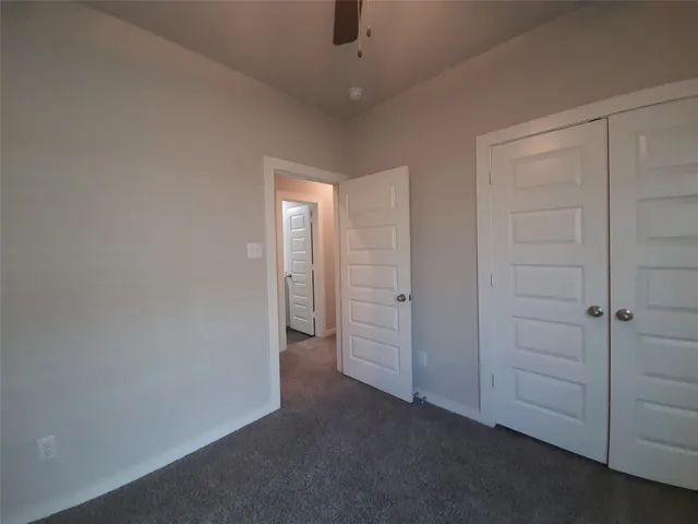 an empty room with closet area