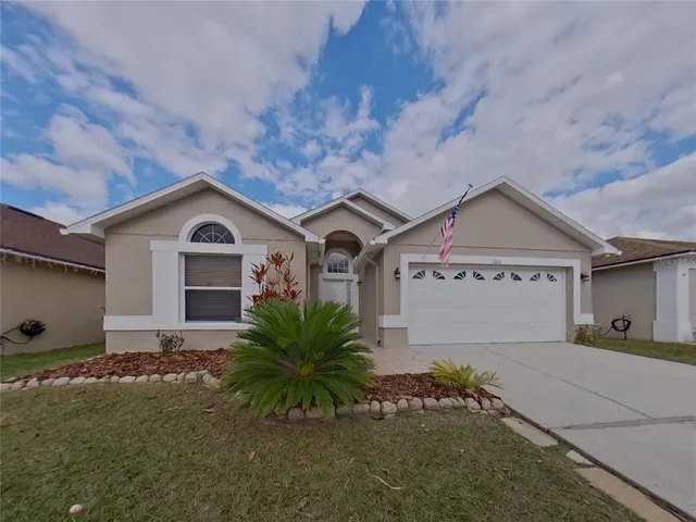 a front view of house with yard and green space