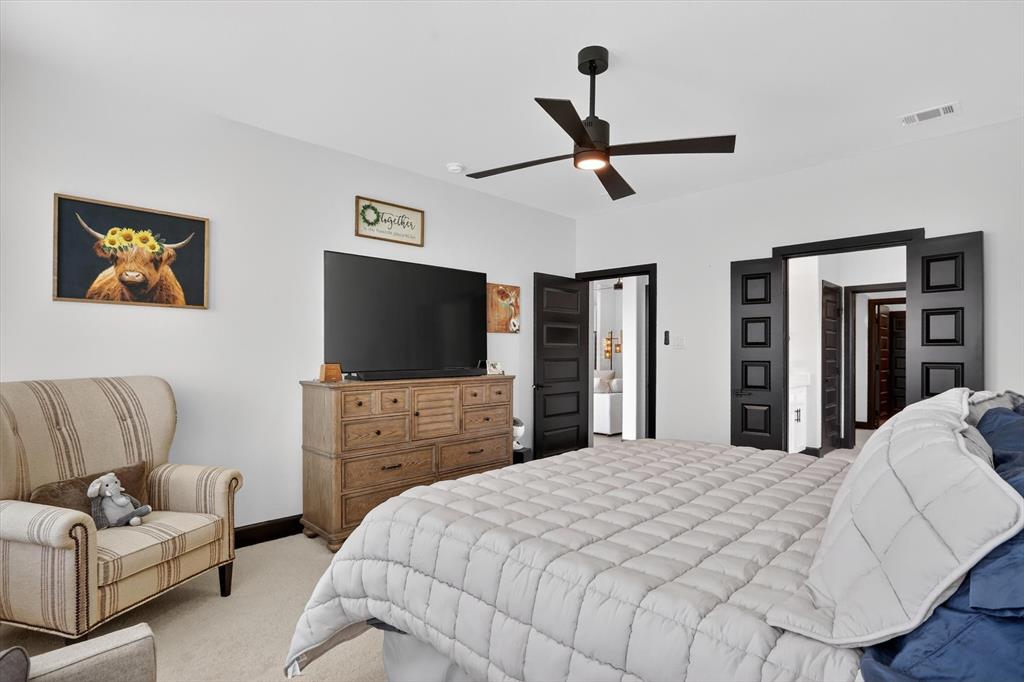 1740 Reverie Road Burleson, TX 76028 - Photo 29 of 37 a bedroom with a bed and a flat screen tv