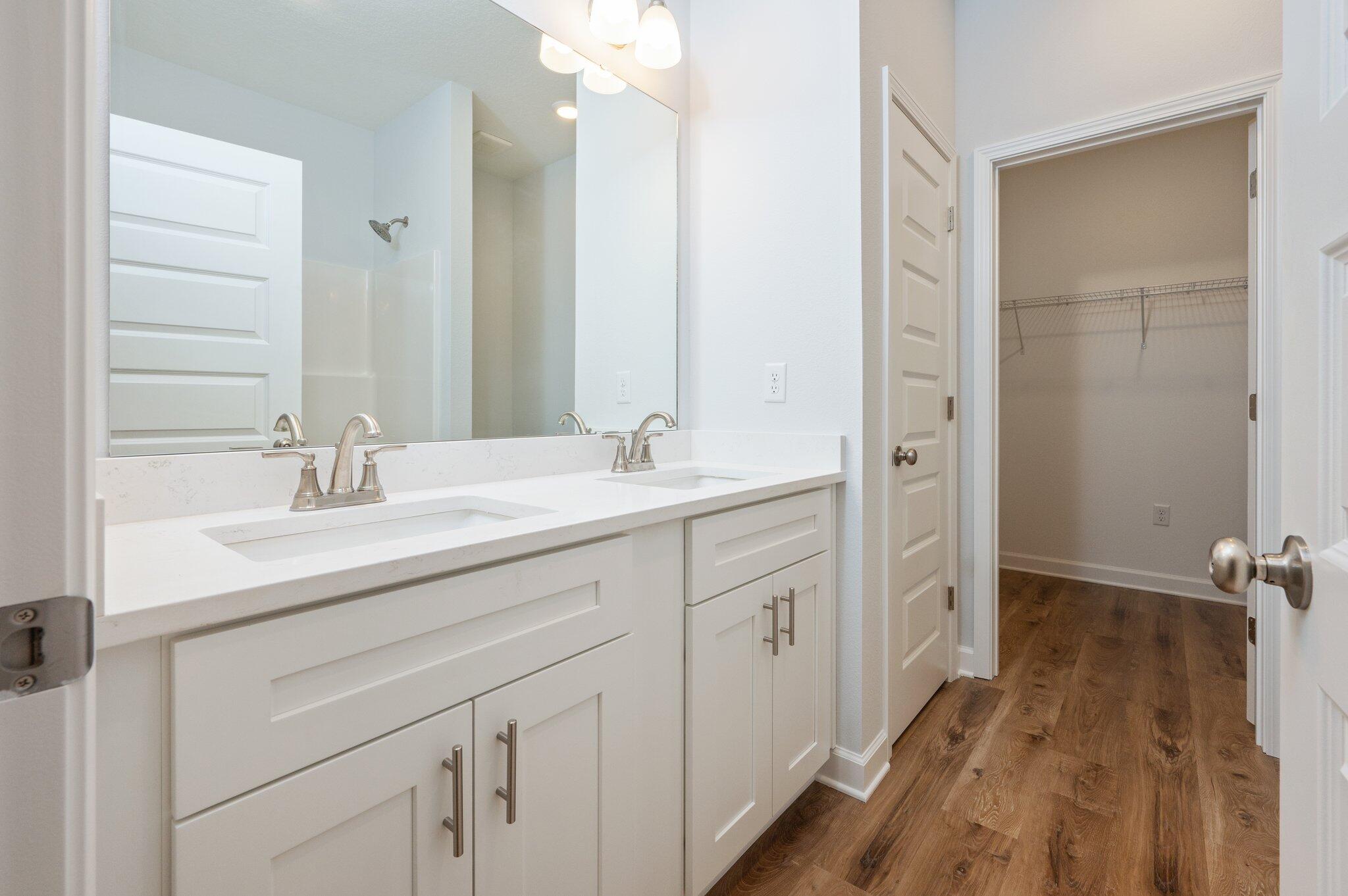 585 Brock Avenue Crestview, FL 32539 - Photo 24 of 29 a bathroom with a double vanity sink a mirror and a shower