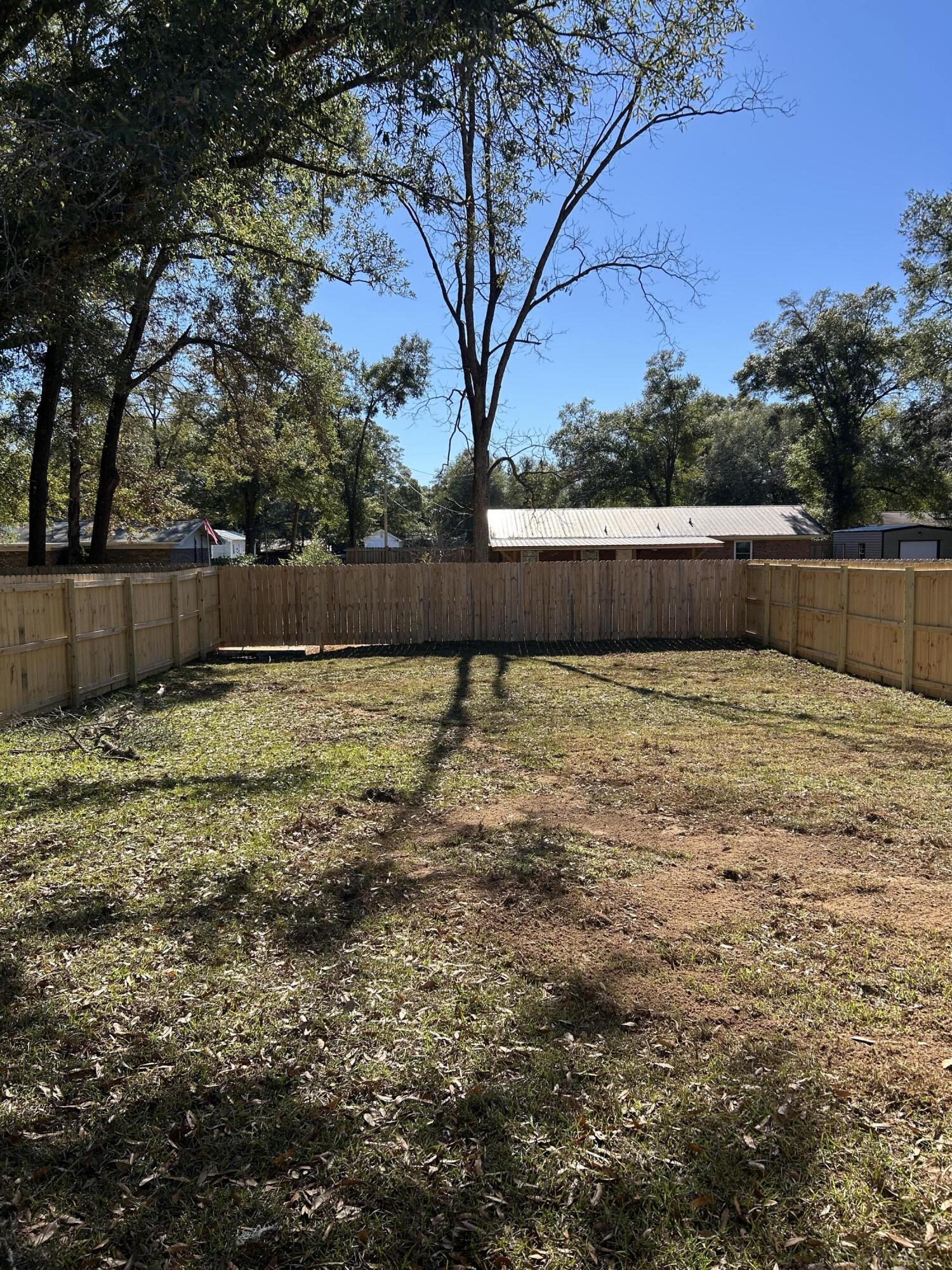 585 Brock Avenue Crestview, FL 32539 - Photo 3 of 29 a view of a yard with large tree