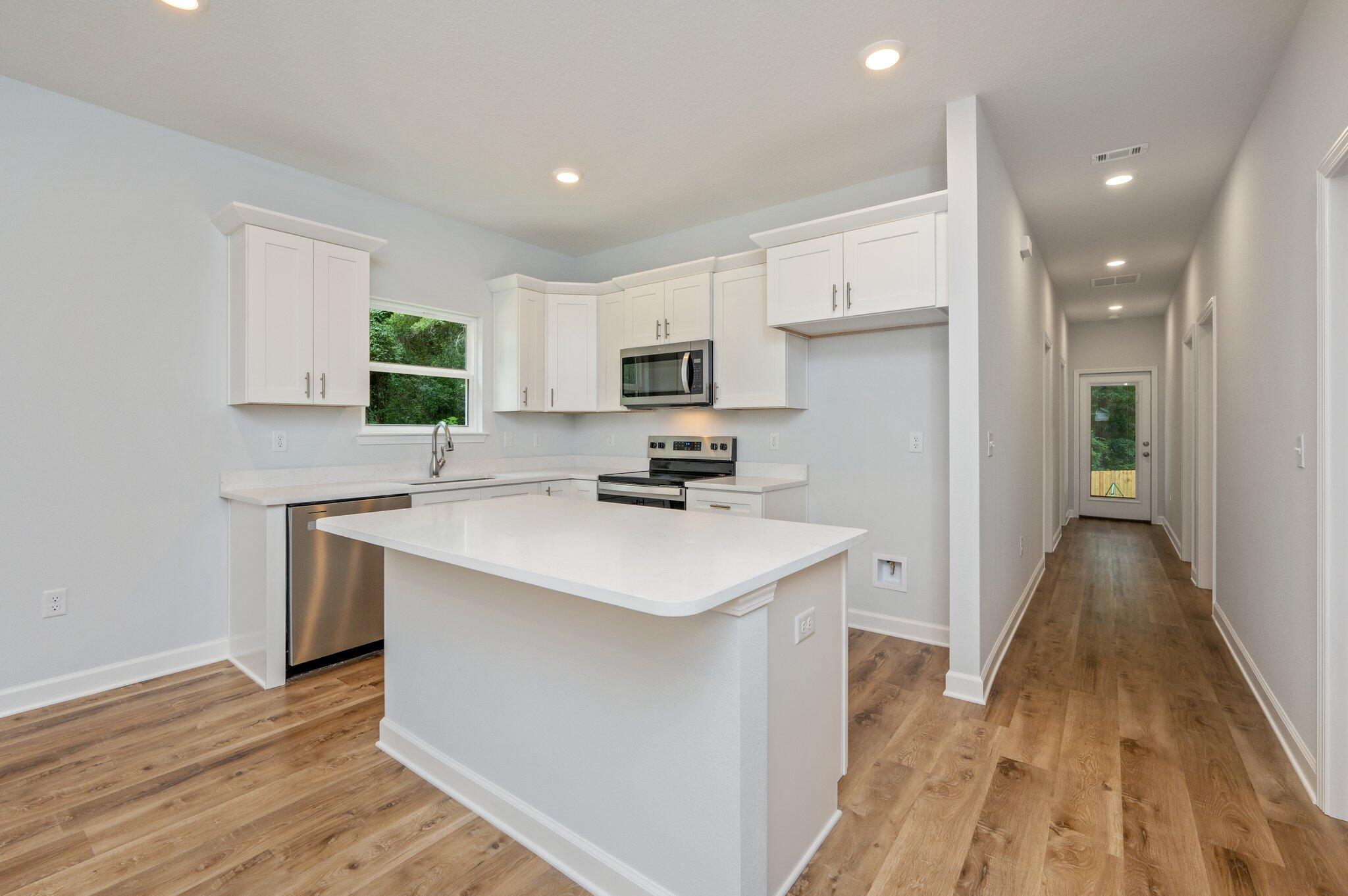 585 Brock Avenue Crestview, FL 32539 - Photo 7 of 29 a kitchen with a sink stove and refrigerator