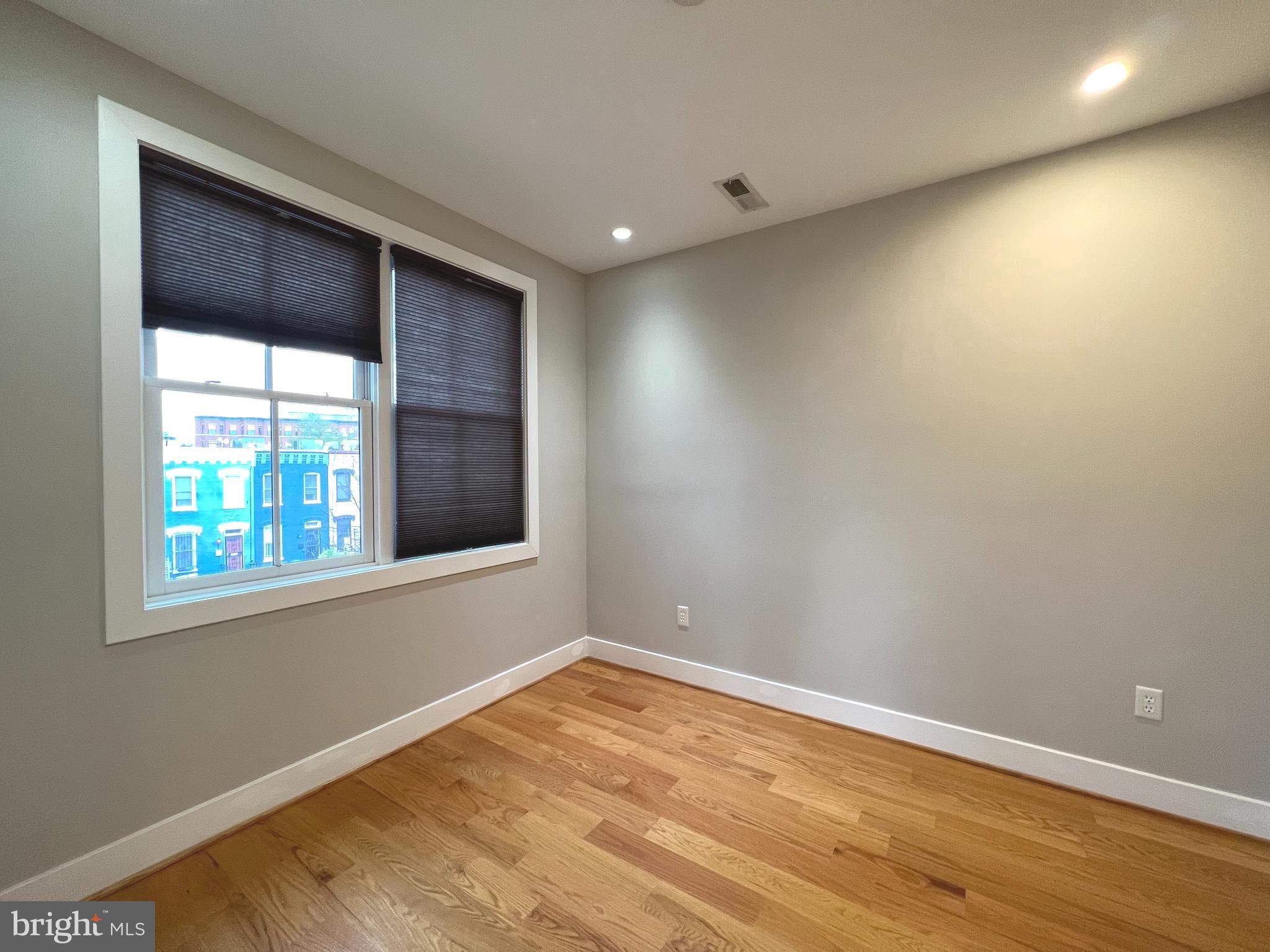 1209 G Street Southeast, Unit 8 Washington, DC 20003 - Photo 12 of 27 a view of empty room with wooden floor and fan
