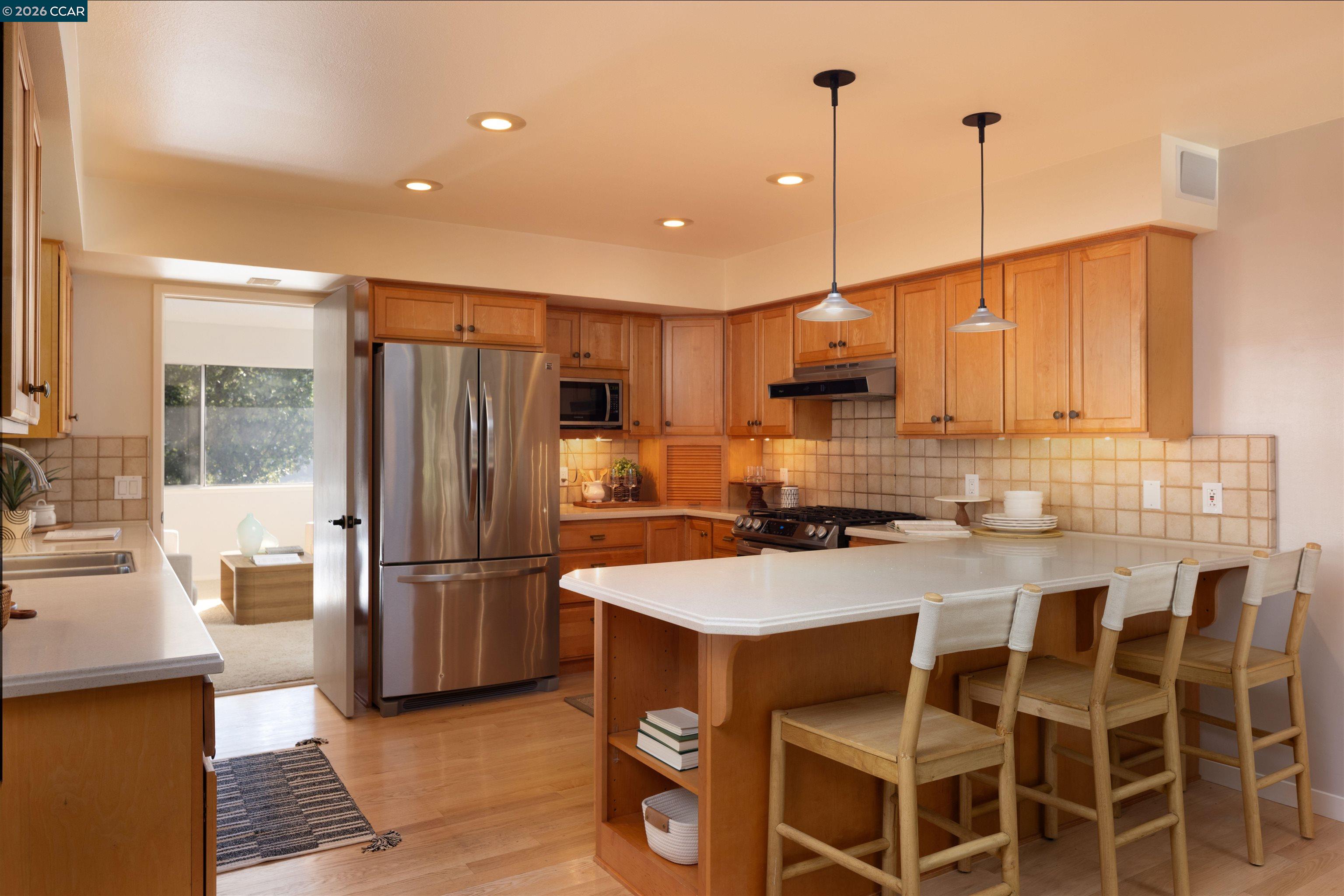 12 Marquard Road Carmel Valley, CA 93924 - Photo 15 of 36 a kitchen with kitchen island granite countertop a sink a counter top space appliances and cabinets