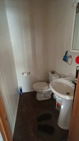 a white toilet sitting next to a bathroom sink