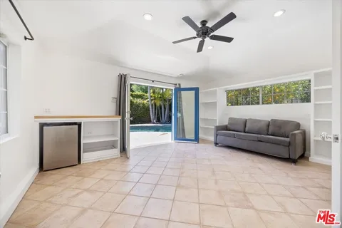 a living room with furniture and a ceiling fan