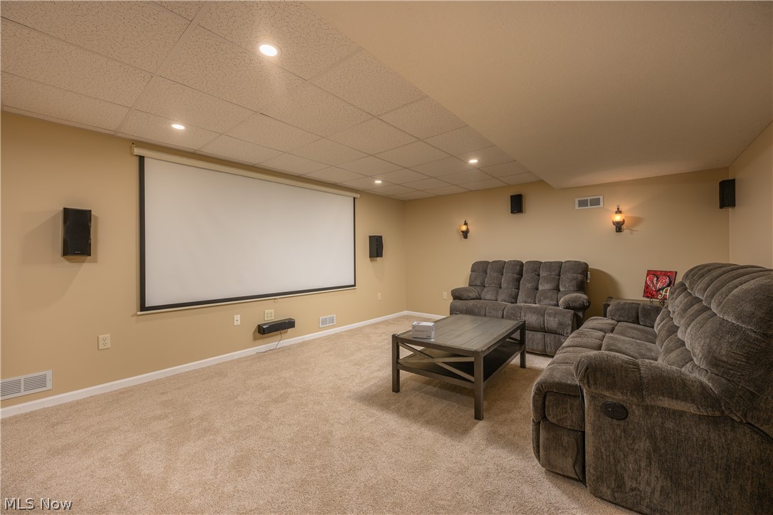 806 Forrest Ridge Drive Dover, OH 44622 - Photo 31 of 36 Home theater featuring light carpet, a drop ceiling, and recessed lighting