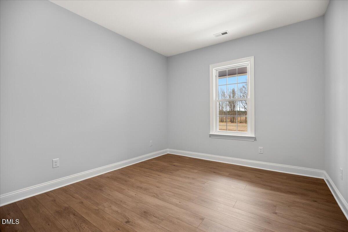 1300 Nick Coley Road Whitakers, NC 27891 - Photo 25 of 47 an empty room with wooden floor and windows