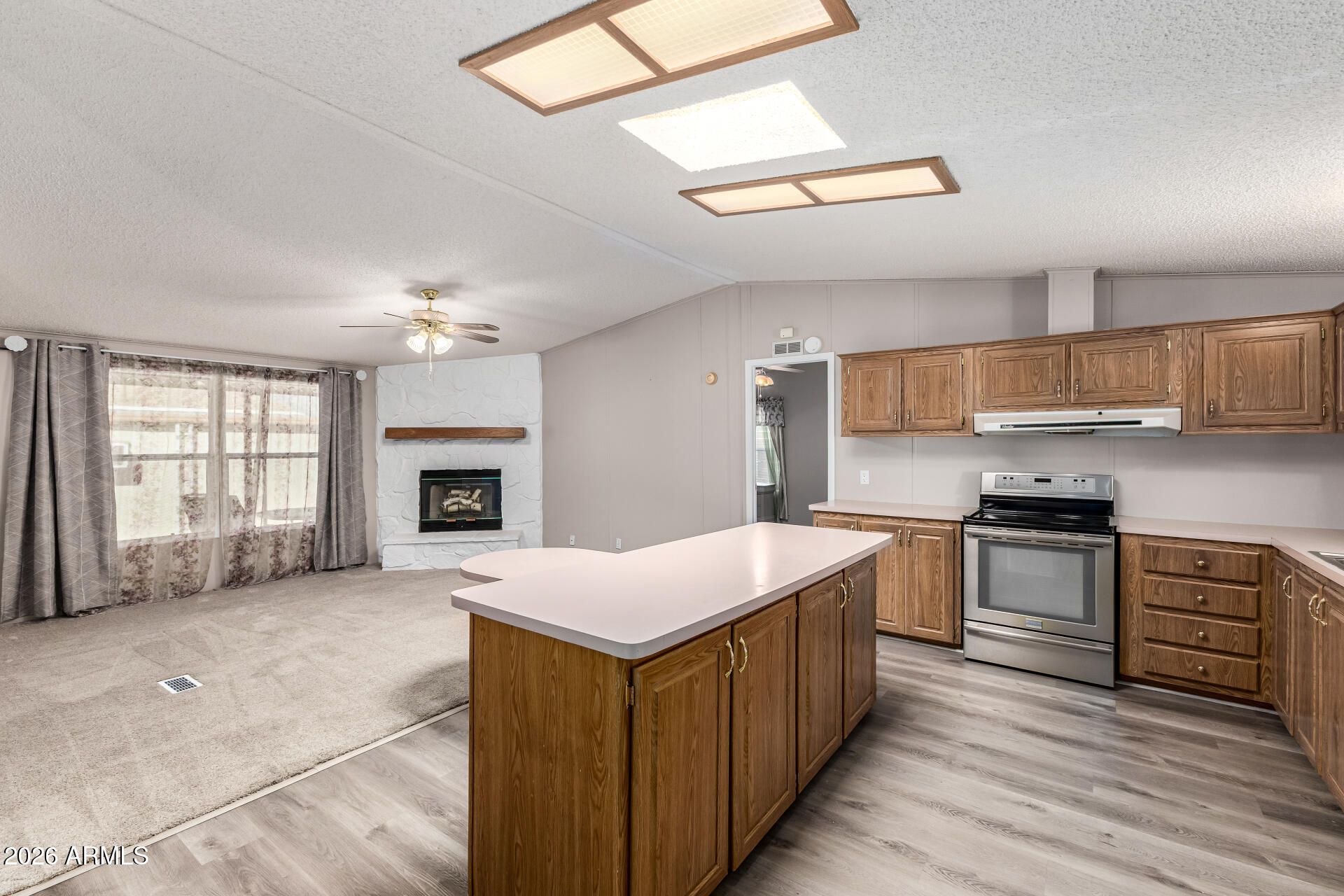 3330 East Main Street, Unit 446 Mesa, AZ 85213 - Photo 12 of 29 a kitchen with a stove a sink and a refrigerator