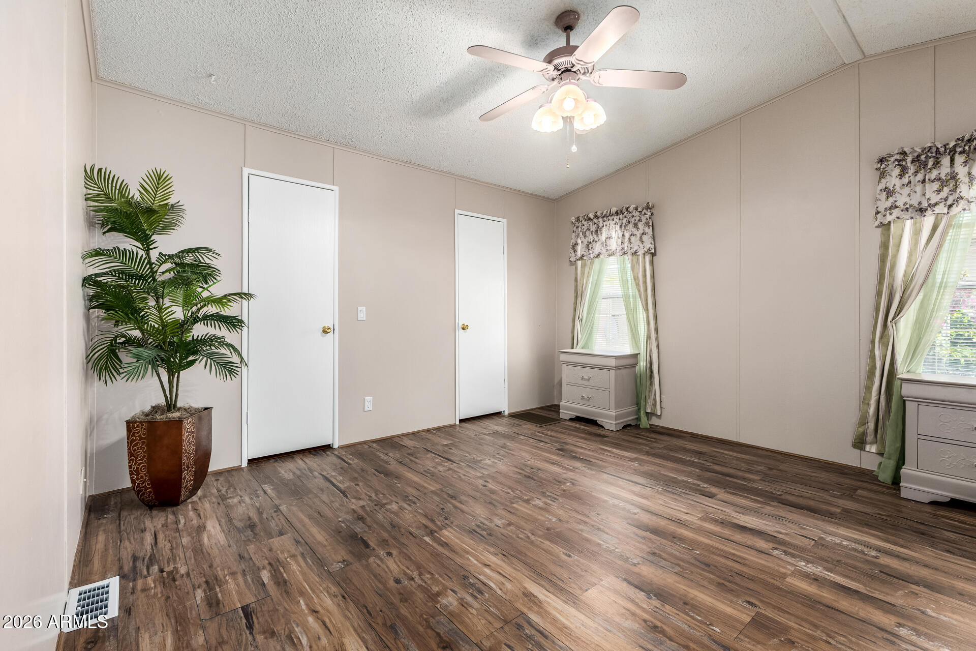 3330 East Main Street, Unit 446 Mesa, AZ 85213 - Photo 14 of 29 a view of an empty room with a window and wooden floor