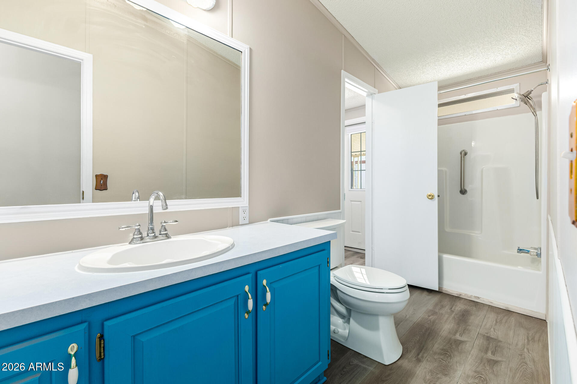 3330 East Main Street, Unit 446 Mesa, AZ 85213 - Photo 21 of 29 a bathroom with a sink a toilet and shower