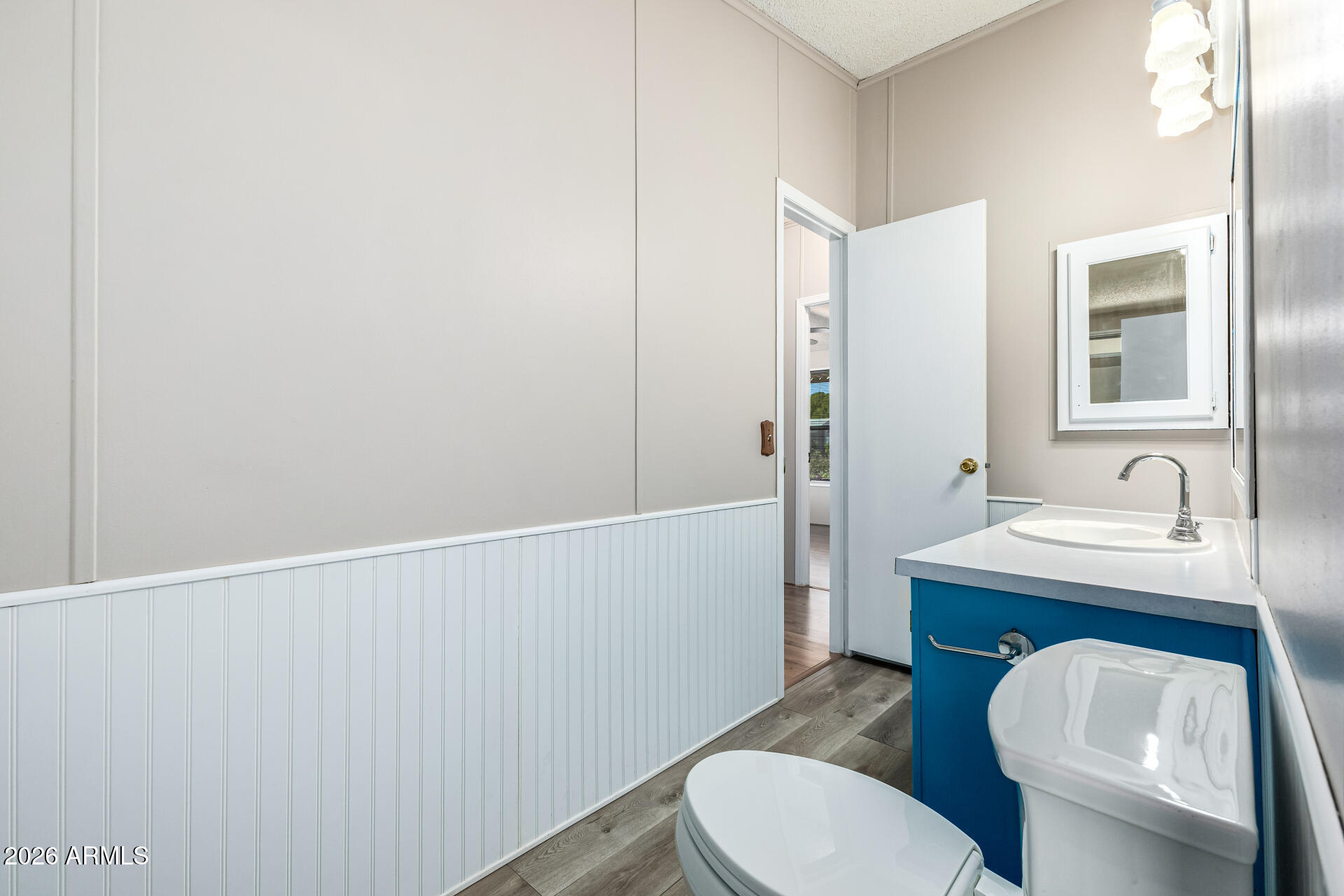 3330 East Main Street, Unit 446 Mesa, AZ 85213 - Photo 22 of 29 a bathroom with a toilet a sink and mirror