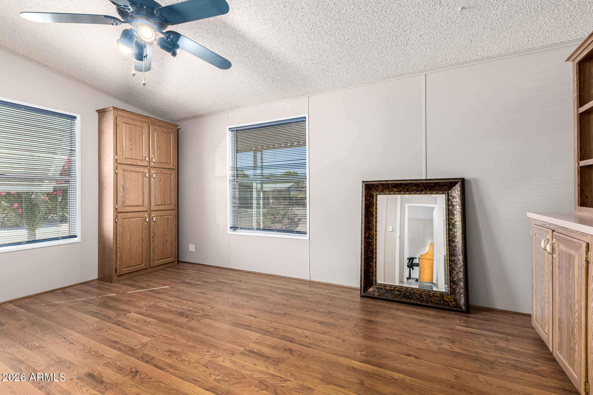 3330 East Main Street, Unit 446 Mesa, AZ 85213 - Photo 23 of 29 a view of an empty room with a window and wooden floor