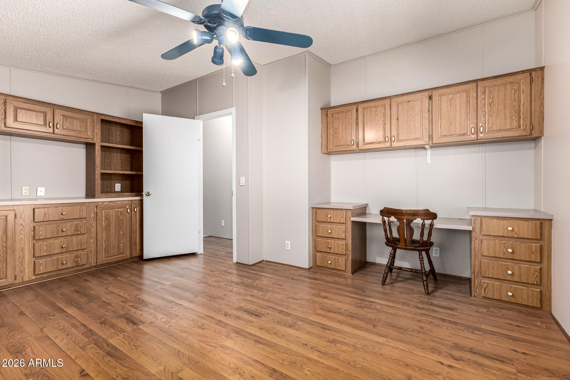 3330 East Main Street, Unit 446 Mesa, AZ 85213 - Photo 24 of 29 a view of a workspace with furniture and wooden floor