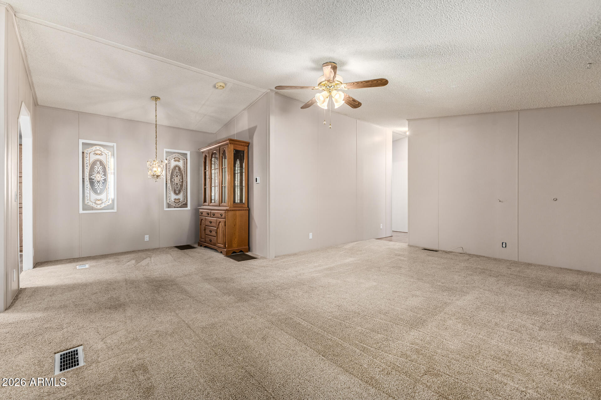 3330 East Main Street, Unit 446 Mesa, AZ 85213 - Photo 5 of 29 an empty room with windows and fan