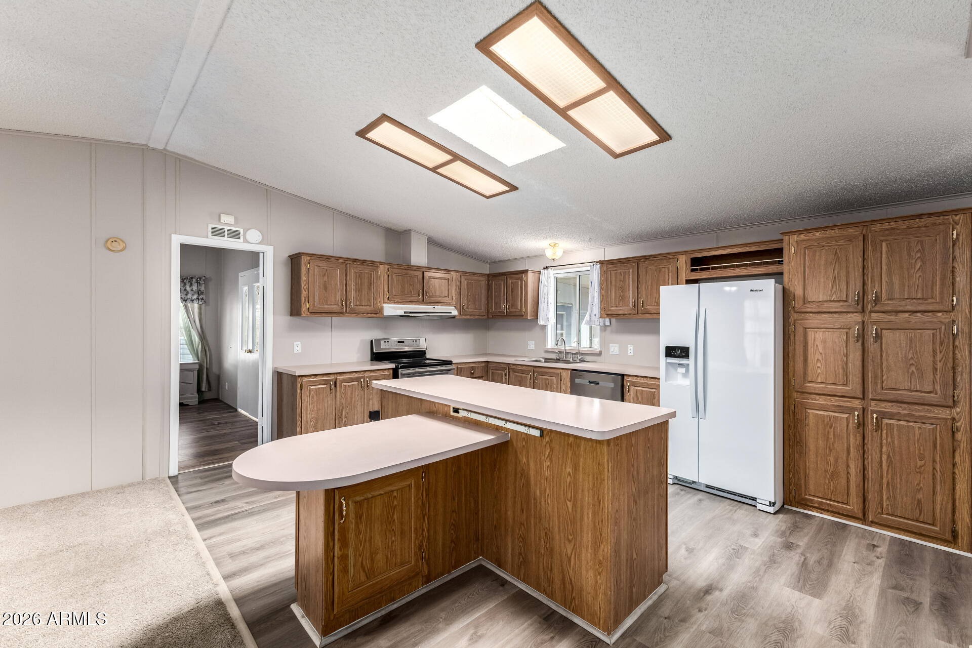 3330 East Main Street, Unit 446 Mesa, AZ 85213 - Photo 10 of 29 a kitchen with refrigerator cabinets and wooden floor