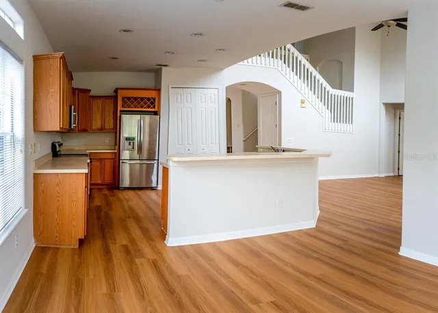 a view of a kitchen with wooden floor and a sink