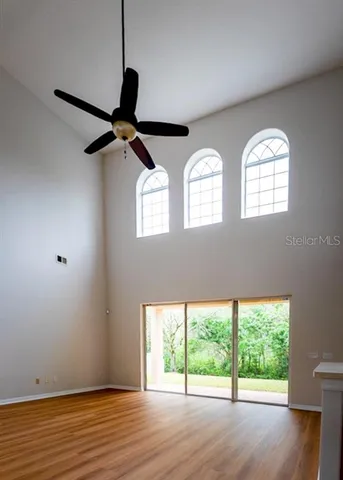 a view of room with wooden floor and windows