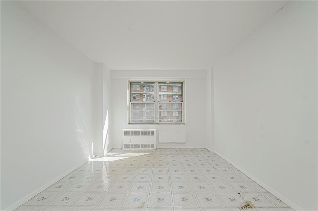 1935 Shore Parkway, Unit 9F Brooklyn, NY 11214 - Photo 16 of 20 an empty room with a empty space and window