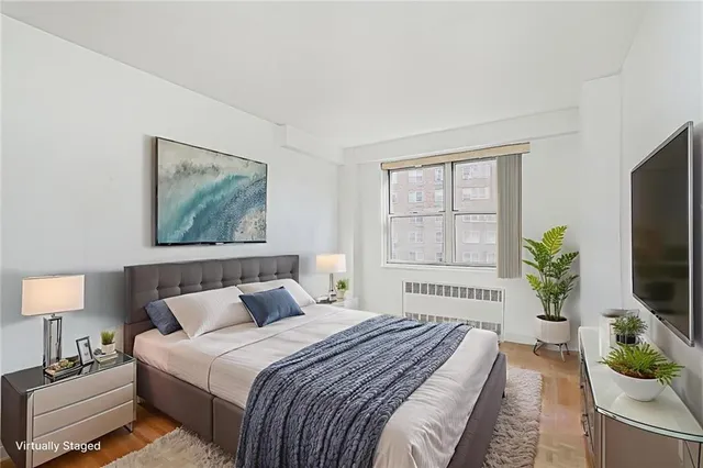 a bedroom with bed windows and a television