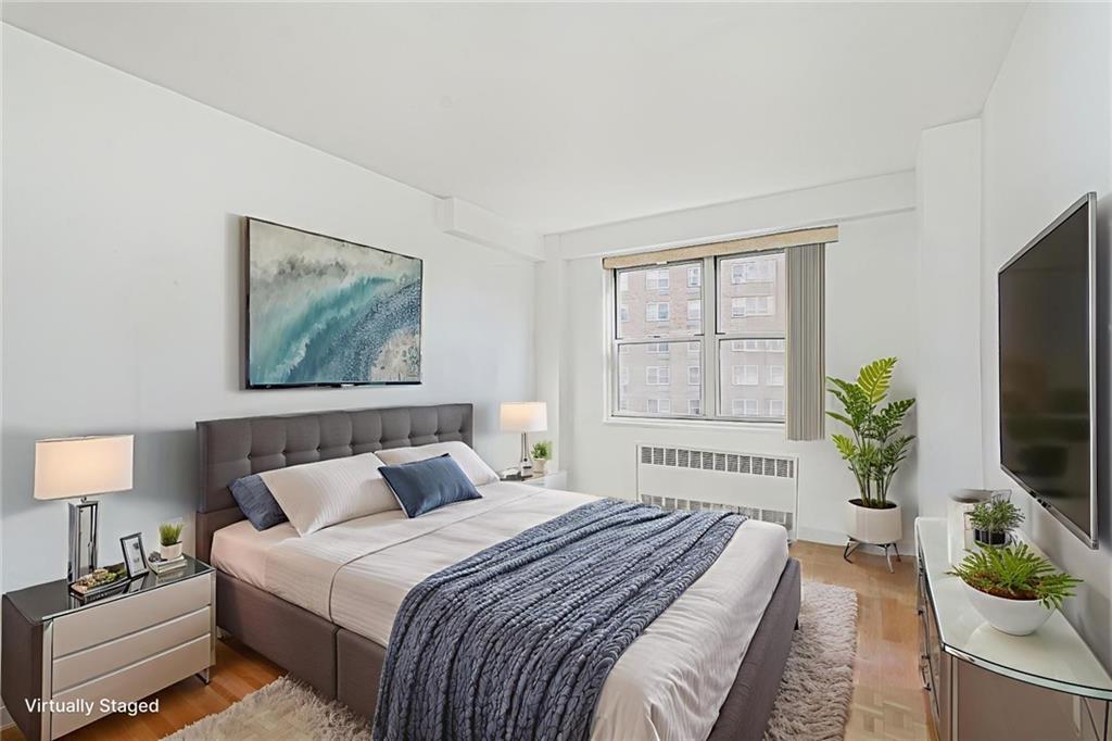 1935 Shore Parkway, Unit 9F Brooklyn, NY 11214 - Photo 18 of 20 a bedroom with bed windows and a television