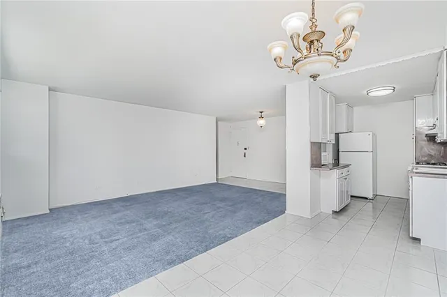 a view of a kitchen with a sink and a refrigerator
