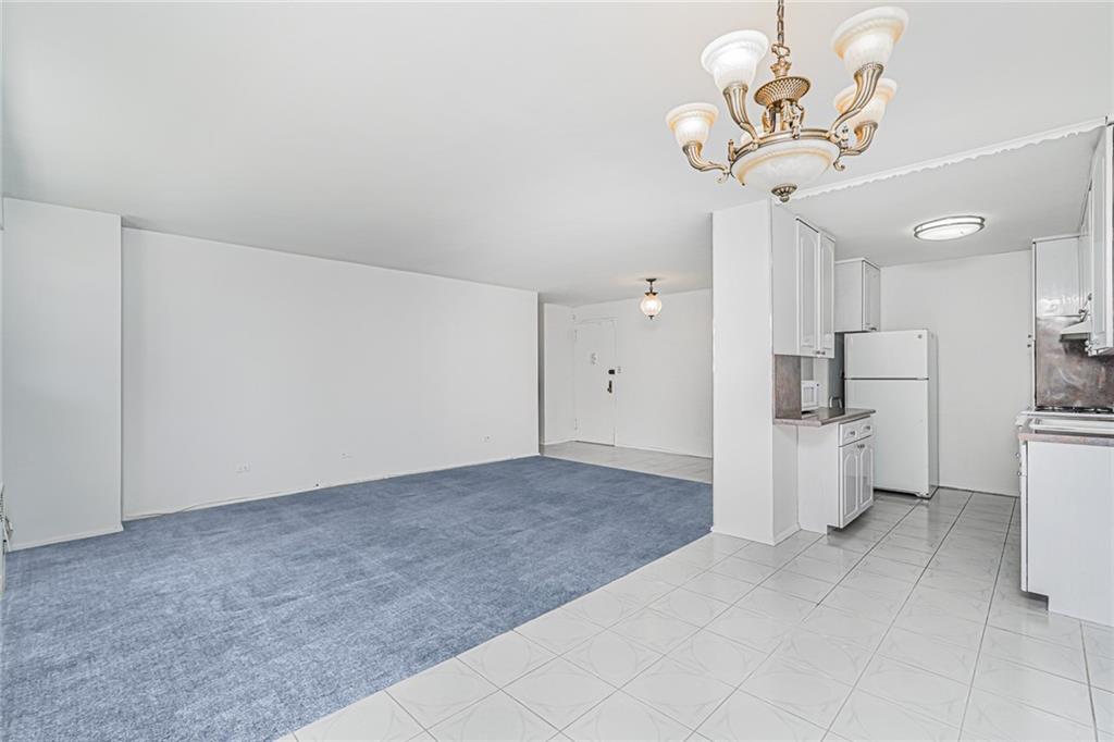 1935 Shore Parkway, Unit 9F Brooklyn, NY 11214 - Photo 7 of 20 a view of a kitchen with a sink and a refrigerator
