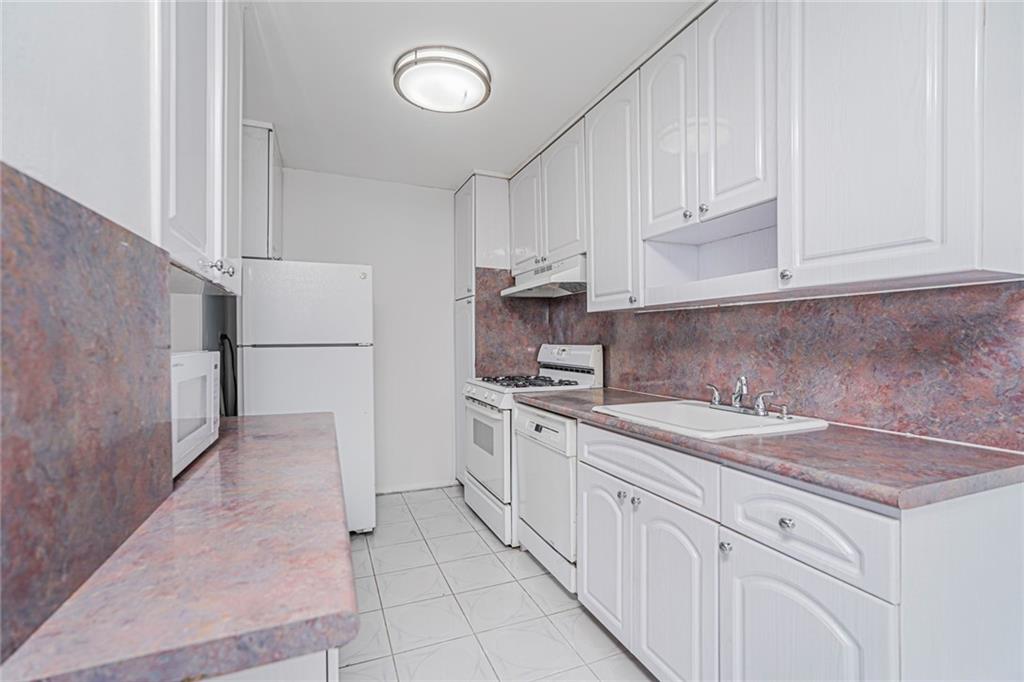 1935 Shore Parkway, Unit 9F Brooklyn, NY 11214 - Photo 10 of 20 a kitchen with a sink and cabinets