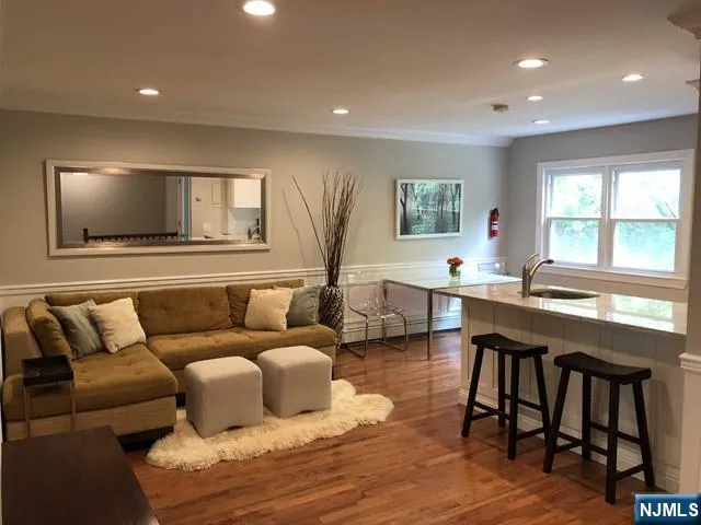 a living room with lots of furniture and a wooden floor