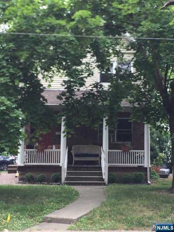 282 South Broad Street, Unit 2 FRONT DOOR Ridgewood, NJ 07450 - Photo 10 of 13 a view of a deck with a large tree and wooden fence