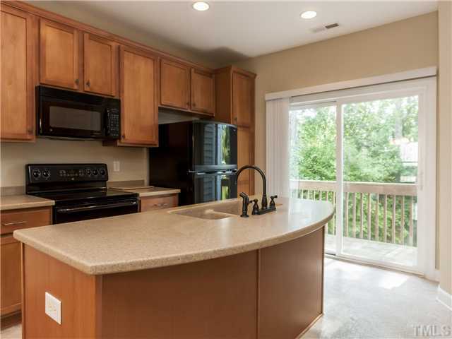 8010 Beech Tree Ridge Trail Raleigh, NC 27612 - Photo 8 of 24 The Dream Kitchen has neutral floors that coordinate well with the living room?s stone fireplace, There?s a center island, tall maple cabinets with tons of storage, Solid Surface Counters, a cabinet pantry and recessed lighting.