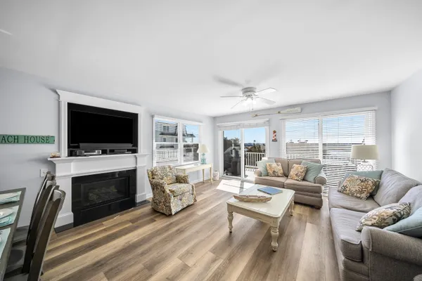 a living room with furniture fireplace and a flat screen tv