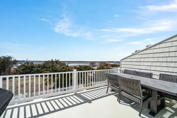 a view of a roof deck with wooden floor and fence