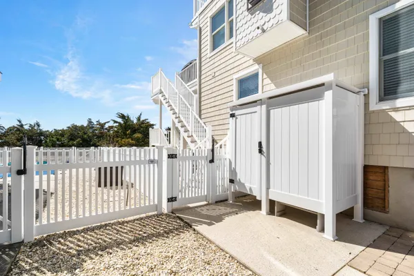 a backyard of a house with wooden floor and fence