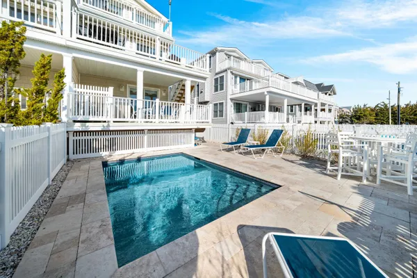 a front view of a house with a yard table and chairs