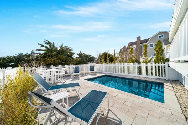 a view of a balcony with wooden floor and outdoor seating