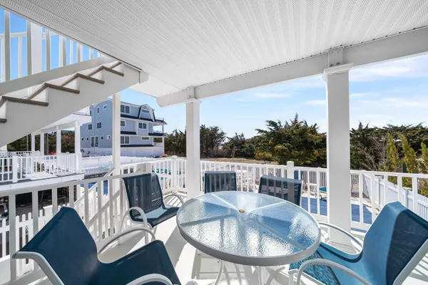 a balcony with table and chairs