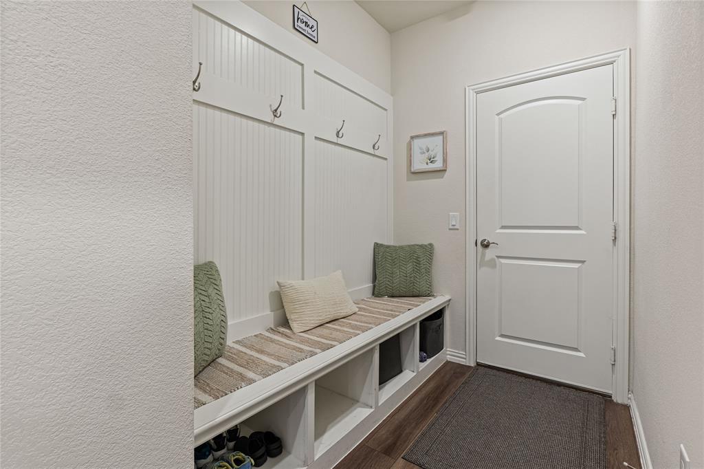 9517 Sunset Lane Oak Point, TX 75068 - Photo 18 of 40 9517 Sunset Lane, Oak Point, TX 75068 - mud room - Mudroom with a textured wall and dark wood finished floors