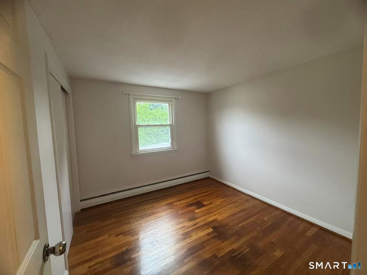 1122 Fienemann Road Farmington, CT 06032 - Photo 12 of 26 an empty room with wooden floor and windows