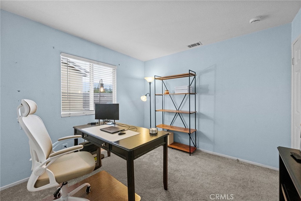 7220 Cumberland Place Rancho Cucamonga, CA 91739 - Photo 29 of 41 North-facing bedroom with plush carpet is currently set up as a home office, ideal for remote work.
