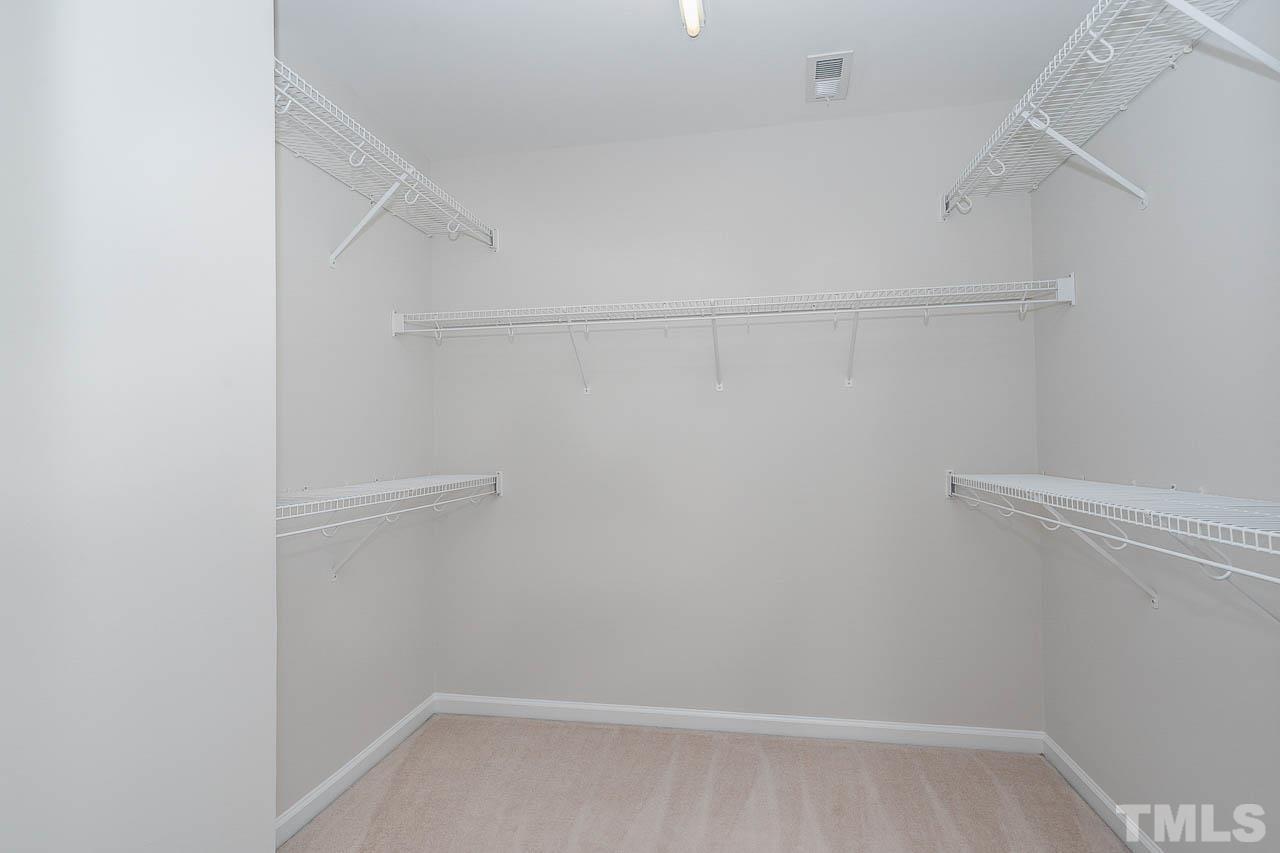 7468 Silver View Lane Raleigh, NC 27613 - Photo 20 of 31 a view of a room with racks on the wall