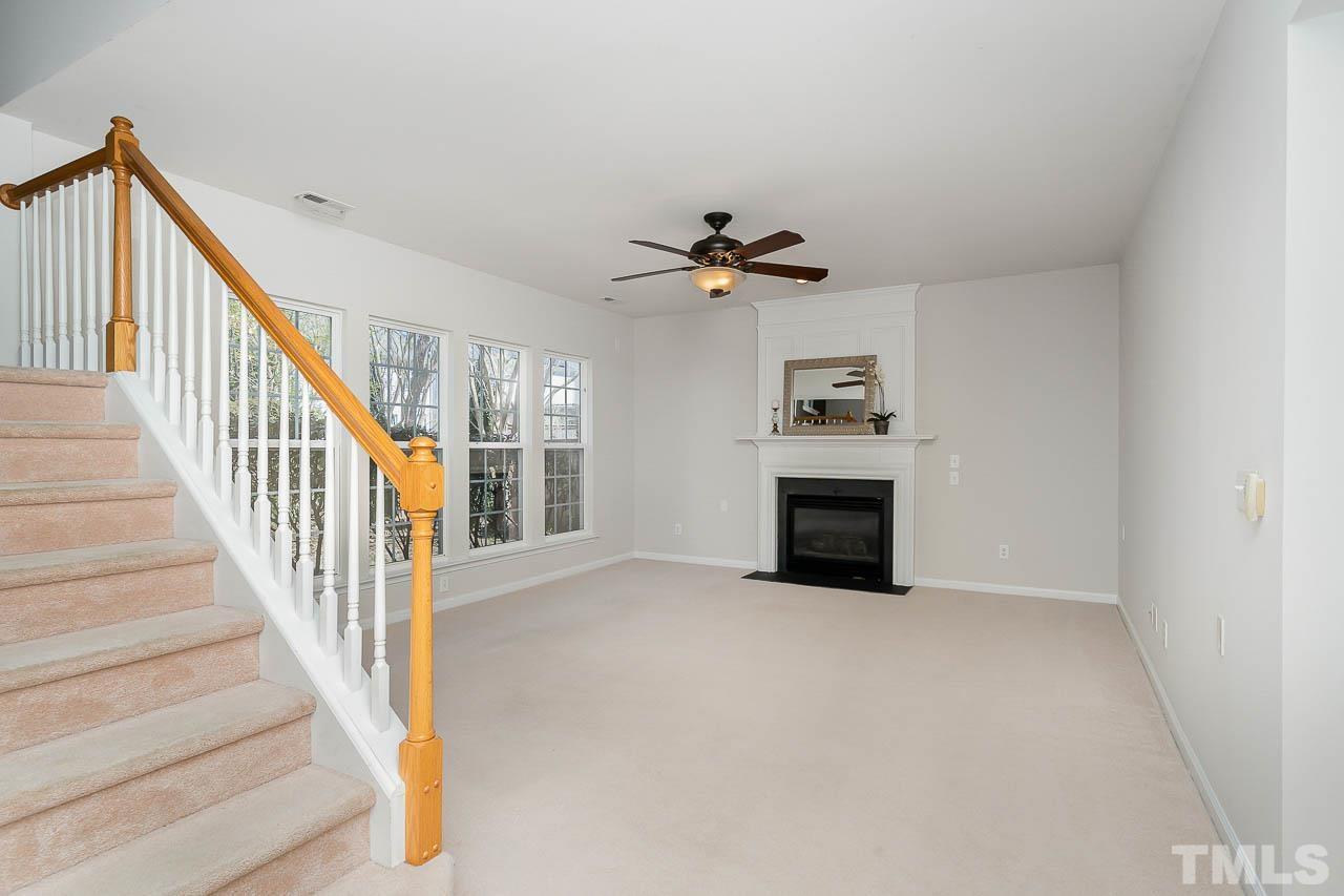 7468 Silver View Lane Raleigh, NC 27613 - Photo 8 of 31 a view of an empty room with a fireplace