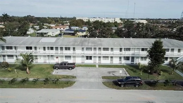 an aerial view of a house with a garden and lake view