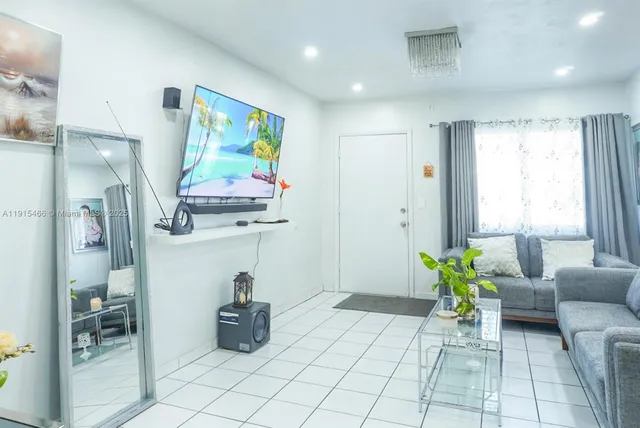 a kitchen with white cabinets and refrigerator
